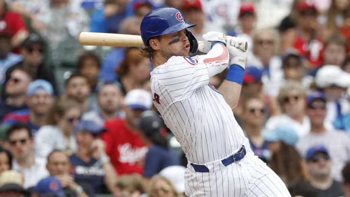 Jul 4, 2024; Chicago, Illinois, USA; Chicago Cubs second baseman Nico Hoerner (2) hits an RBI-single against the Philadelphia Phillies during the fourth inning at Wrigley Field