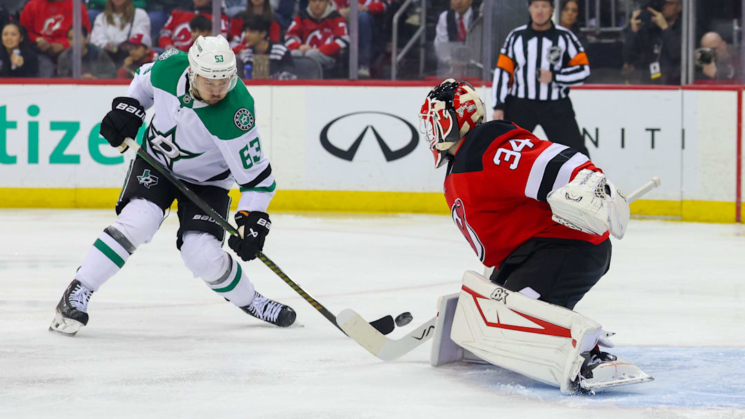 New Jersey Devils goaltender Jake Allen (34) makes a save on Dallas Stars right wing Evgenii Dadonov (63). Mandatory Credit: Ed Mulholland-Imagn Images