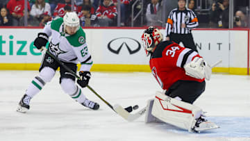New Jersey Devils goaltender Jake Allen (34) makes a save on Dallas Stars right wing Evgenii Dadonov (63). Mandatory Credit: Ed Mulholland-Imagn Images
