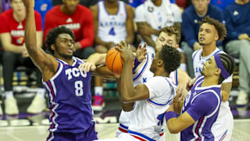 TCU players Ernest Udeh Jr. and David Punch defend against the Kansas Jayhawks. 