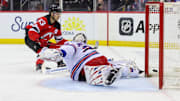 New Jersey Devils left wing Jesper Bratt scores a goal on New York Rangers goaltender Igor Shesterkin.