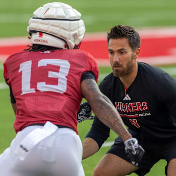 Nebraska assistant wide receivers coach Andrew Verboys works with wideout Nyziah Hunter at the Big Red Preview.