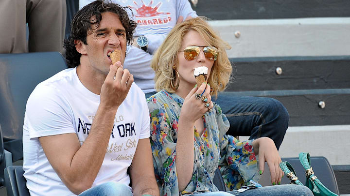 AS Roma's forward Luca Toni (L) eats and AS Roma's forward Luca Toni (L) eats and