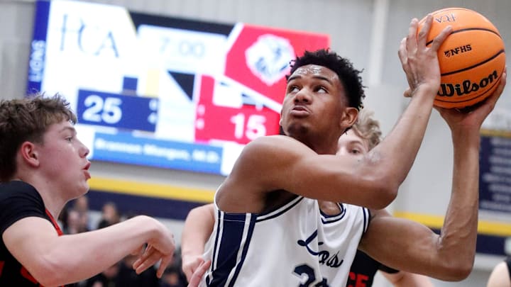 PCA's Chris Washington Jr. (33) looks before going up for a shot as Grace Christian Academy's Chase Benham (30) guards him during the boys' basketball game on Friday, Feb. 6, 2026.