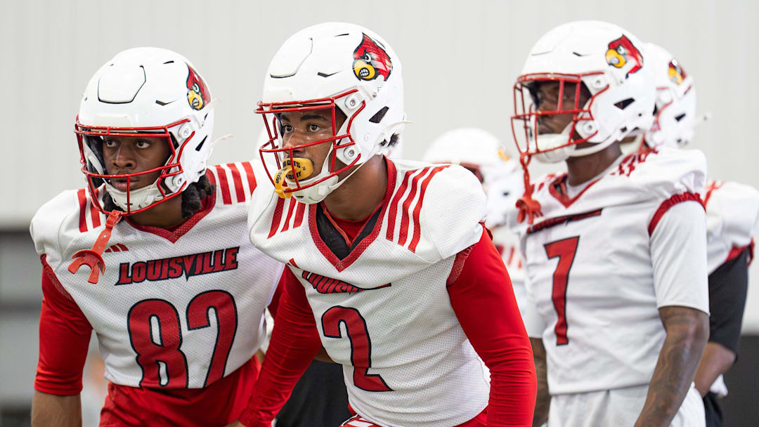 Louisville wide receivers T.J. McWilliams (82), TreyShun Hurry (2) and Lawayne McCoy (7) run drills during practice.