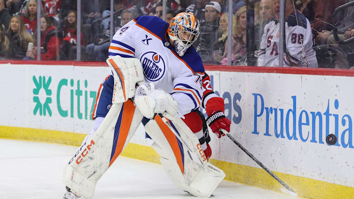 Mar 13, 2025; Newark, New Jersey, USA; Edmonton Oilers goaltender Stuart Skinner (74) plays the puck against the New Jersey Devils during the second period at Prudential Center. Mandatory Credit: Ed Mulholland-Imagn Images