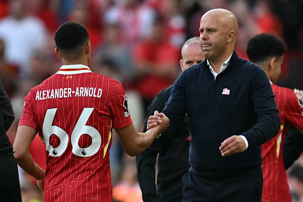 Trent Alexander-Arnold (left) shaking Arne Slot's hand.