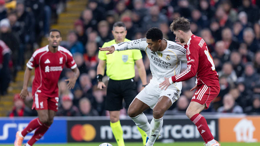 Jude Bellingham protects the ball from Liverpool’s Alexis Mac Allister