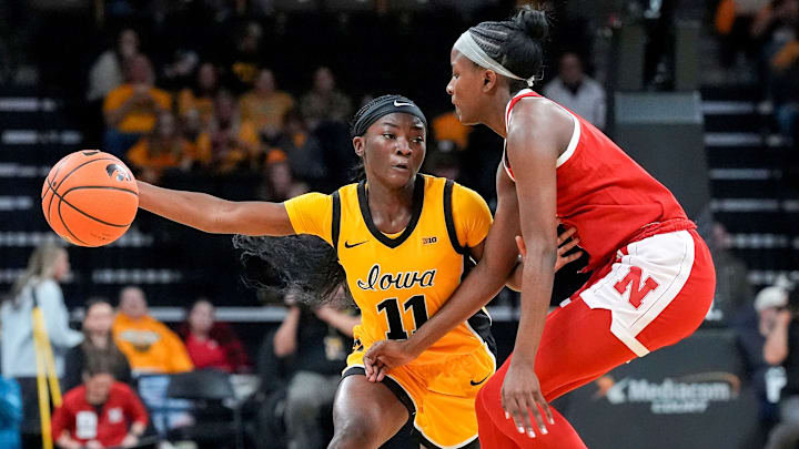 Iowa guard Chit-Chat Wright (11) brings the ball up court against Nebraska guard Hailey Weaver (1) Jan. 1, 2026 at Carver-Hawkeye Arena in Iowa City, Iowa.