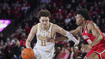 Dec 3, 2024; Athens, Georgia, USA; Notre Dame Fighting Irish guard Braeden Shrewsberry (11) dribbles against Georgia Bulldogs forward RJ Godfrey (10) during the second half at Stegeman Coliseum. Mandatory Credit: Dale Zanine-Imagn Images