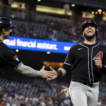 Sep 3, 2024; San Francisco, California, USA;  Arizona Diamondbacks third baseman Eugenio Suárez (28) is congratulated by left fielder Randal Grichuk (15) after he scored against the San Francisco Giants during the third inning at Oracle Park.