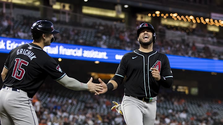 Sep 3, 2024; San Francisco, California, USA;  Arizona Diamondbacks third baseman Eugenio Suárez (28) is congratulated by left fielder Randal Grichuk (15) after he scored against the San Francisco Giants during the third inning at Oracle Park.