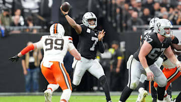 Nov 23, 2025; Paradise, Nevada, USA; Las Vegas Raiders quarterback Geno Smith (7) passes against Cleveland Browns defensive end Cameron Thomas (99) in the first half at Allegiant Stadium. Mandatory Credit: Stephen R. Sylvanie-Imagn Images