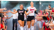 Aug 30, 2023; Lincoln, NE, USA; Nebraska Cornhuskers outside hitter Merritt Beason (13) and libero Lexi Rodriguez (8) run out of the tunnel before the match against the Omaha Mavericks at Memorial Stadium.