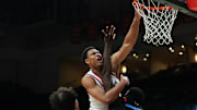 Nov 23, 2025; Coral Gables, Florida, USA; Miami Hurricanes forward Malik Reneau (5) dunks against Delaware State Hornets forward Cyril Obasogie (10) during the first half at Watsco Center. Mandatory Credit: Sam Navarro-Imagn Images