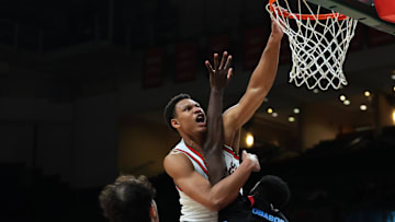 Nov 23, 2025; Coral Gables, Florida, USA; Miami Hurricanes forward Malik Reneau (5) dunks against Delaware State Hornets forward Cyril Obasogie (10) during the first half at Watsco Center. Mandatory Credit: Sam Navarro-Imagn Images