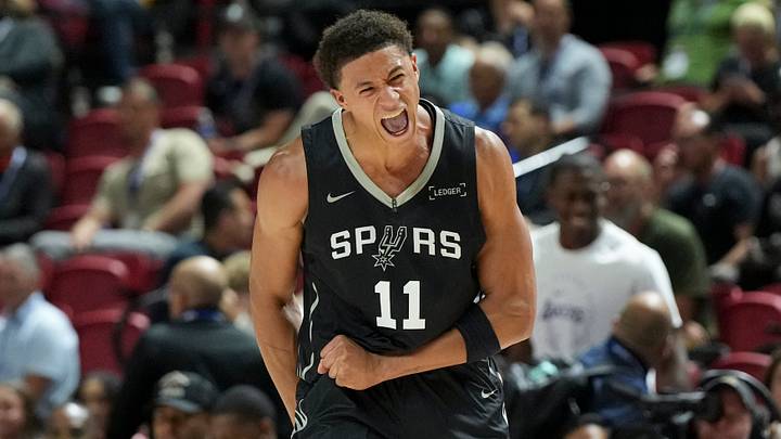 Jul 10, 2025; Las Vegas, NV, USA; San Antonio Spurs forward Carter Bryant (11) reacts to a play against the Philadelphia 76ers in the first quarter of their game at Thomas & Mack Center. Mandatory Credit: Candice Ward-Imagn Images