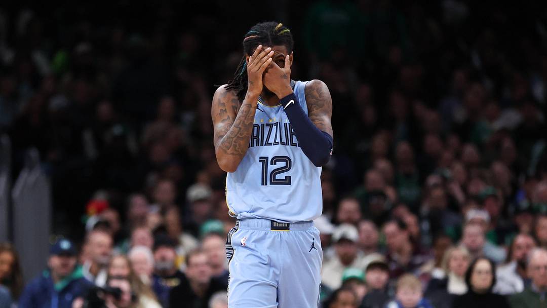 Dec 7, 2024; Boston, Massachusetts, USA; Memphis Grizzlies guard Ja Morant (12) reacts after being hit in the face during the second half against the Boston Celtics at TD Garden. 