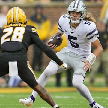 Sep 16, 2023; Columbia, Missouri, USA; Kansas State Wildcats quarterback Avery Johnson (5) runs the ball against Missouri Tigers defensive back Joseph Charleston (28) during the second half at Faurot Field at Memorial Stadium. Mandatory Credit: Jay Biggerstaff-Imagn Images