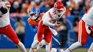 Jan 5, 2025; Denver, Colorado, USA; Kansas City Chiefs quarterback Carson Wentz (11) is sacked by Denver Broncos linebacker Nik Bonitto (15) in the third quarter at Empower Field at Mile High. Mandatory Credit: Isaiah J. Downing-Imagn Images