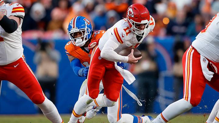 Jan 5, 2025; Denver, Colorado, USA; Kansas City Chiefs quarterback Carson Wentz (11) is sacked by Denver Broncos linebacker Nik Bonitto (15) in the third quarter at Empower Field at Mile High. Mandatory Credit: Isaiah J. Downing-Imagn Images