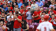 Jul 8, 2025; Cincinnati, Ohio, USA; Fans cheer as Cincinnati Reds second baseman Matt McLain (9) crosses the plate after hitting a solo home run in the first inning against the Miami Marlins at Great American Ball Park. Mandatory Credit: Katie Stratman-Imagn Images