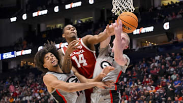 Mar 12, 2025; Nashville, TN, USA;  Oklahoma Sooners forward Jalon Moore (14), Georgia Bulldogs forward Asa Newell (14), and guard Blue Cain (0) fight for the ball during the second half at Bridgestone Arena. Mandatory Credit: Steve Roberts-Imagn Images