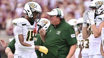 Sep 2, 2023; Starkville, Mississippi, USA; Southeastern Lousiana Lions head coach Frank Scelfo speaks with defensive back Coryell Pierce (18) during the second quarter of the game against the Mississippi State Bulldogs at Davis Wade Stadium at Scott Field.