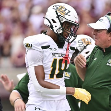 Southeastern Lousiana Lions head coach Frank Scelfo speaks with defensive back Coryell Pierce (18) during the second quarter of the game against Mississippi State