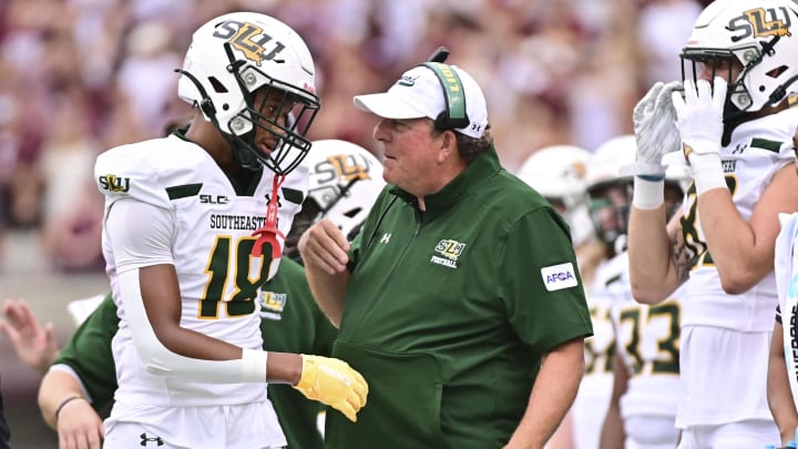 Sep 2, 2023; Starkville, Mississippi, USA; Southeastern Lousiana Lions head coach Frank Scelfo speaks with defensive back Coryell Pierce (18) during the second quarter of the game against the Mississippi State Bulldogs at Davis Wade Stadium at Scott Field.