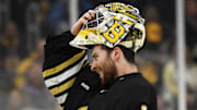 Boston Bruins goaltender Jeremy Swayman adjusts his mask during game four of the second round of the 2024 Stanley Cup Playoffs.