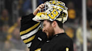 May 12, 2024; Boston, Massachusetts, USA; Boston Bruins goaltender Jeremy Swayman (1) slips on his mask during the second period in game four of the second round of the 2024 Stanley Cup Playoffs against the Florida Panthers at TD Garden. Mandatory Credit: Bob DeChiara-Imagn Images