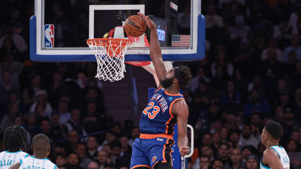Nov 28, 2023; New York, New York, USA; New York Knicks center Mitchell Robinson (23) dunks in front of Charlotte Hornets center Mark Williams (5) and guard Terry Rozier (3) and forward Brandon Miller (24) during the second half at Madison Square Garden. Mandatory Credit: Vincent Carchietta-USA TODAY Sports