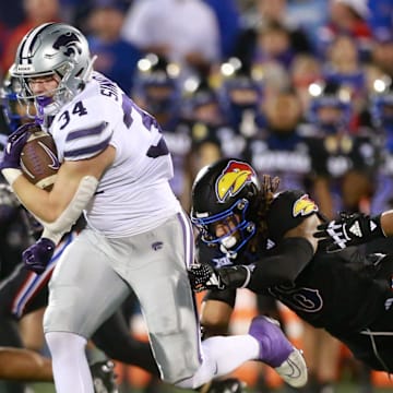 Kansas State junior tight end Ben Sinnott (34) drives through Kansas defenders during the first quarter of Saturday's Sunflower Showdown against Kansas inside David Booth Kansas Memorial Stadium.