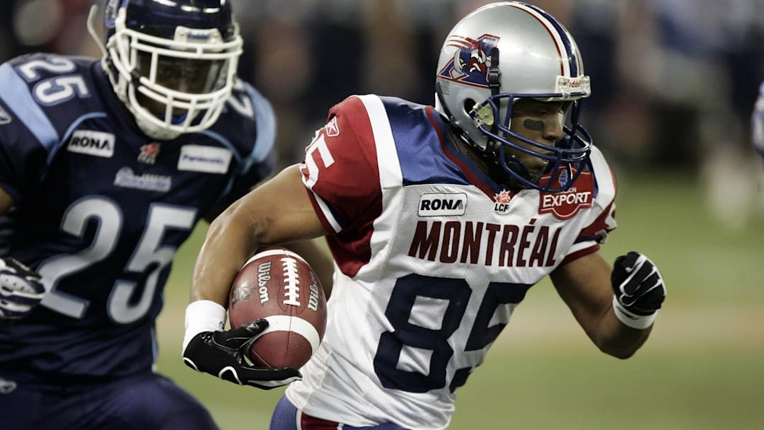 October 12, 2007; Toronto, ON, Canada; Montreal Alouettes wide receiver (85) Brian Bratton returns a kick-off as Toronto Argonauts defensive back (25) Leron Mitchell gives chase during the second quarter of a game at the Rogers Centre. Mandatory Credit: Photo By John  Sokolowski-Imagn Images