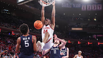 Feb 23, 2025; New York, New York, USA;  St. John's basketball forward Zuby Ejiofor (24) dunks past Connecticut Huskies forward Alex Karaban (11) in the second half at Madison Square Garden. 