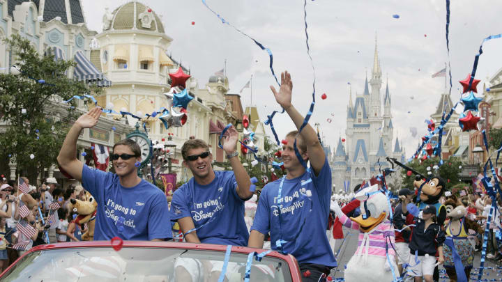 Aug 31, 2004: Lake Buena Vista, FL, USA: Lenny Krayzelburg, Michael Phelps and Ian Crocker wave to the crowd as they parade down Main Street, U.S.A. at Walt Disney World's Magic Kingdom. 
Gold medalists Krayzelburg, Phelps and Crocker visited Walt Disney World today to kickoff a national tour called "Disney's Swim with the Stars". The trio will embark on to 12 cities around the country. Scheduled tour stops include: Atlanta, New York city, Baltimore, Chicago, Dallas, Denver, Las Vegas, Salt Lake