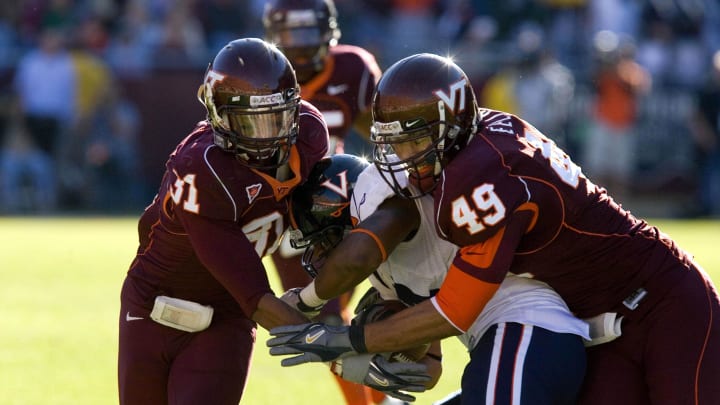 Nov. 25, 2006, Blacksburg, Va, USA;  Virginia Cavaliers wide receiver (84) Fontel Mines is tackled by linebacker (31) Brenden Hill and defensive end (49) Chris Ellis in the Hokies 17-0 victory over the Virginia Cavaliers at Lane Stadium in Blacksburg, VA. Mandatory Credit: Bob Donnan-USA TODAY Sports Copyright © 2006 Bob Donnan