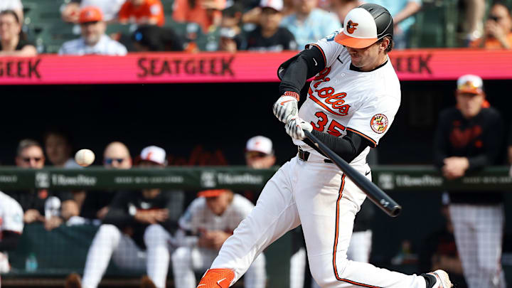Apr 20, 2025; Baltimore, Maryland, USA; Baltimore Orioles catcher Adley Rutschman (35) hits a home run during the eighth inning against the Cincinnati Reds at Oriole Park at Camden Yards.
