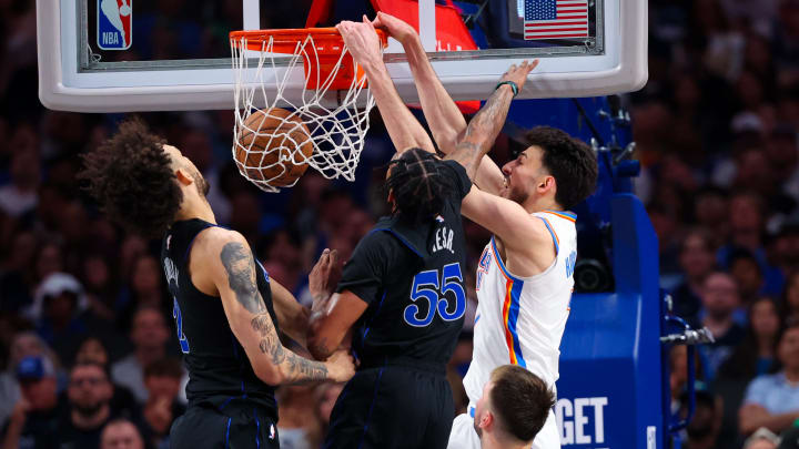 May 18, 2024; Dallas, Texas, USA;  Oklahoma City Thunder forward Chet Holmgren (7) dunks past Dallas Mavericks forward Derrick Jones Jr. (55) and Dallas Mavericks center Dereck Lively II (2) during the second half in game six of the second round of the 2024 NBA playoffs at American Airlines Center. Mandatory Credit: Kevin Jairaj-USA TODAY Sports