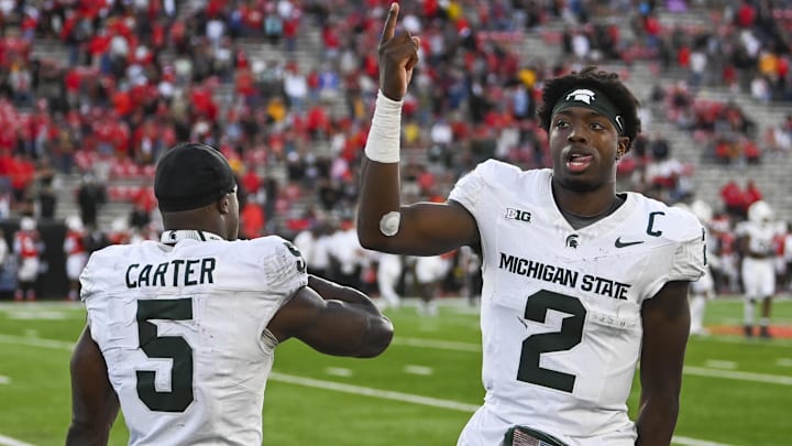 Sep 7, 2024; College Park, Maryland, USA; Michigan State Spartans quarterback Aidan Chiles (2) and  running back Nate Carter (5) celebrate on the sidelines during the second half  against the Maryland Terrapins at SECU Stadium. Mandatory Credit: Tommy Gilligan-Imagn Images