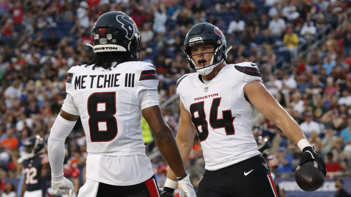 Aug 1, 2024; Canton, Ohio, USA;  Houston Texans tight end Teagan Quitoriano (84) reacts with wide receiver John Metchie III (8) after scoring a touchdown against the Chicago Bears during the first quarter at Tom Benson Hall of Fame Stadium. Mandatory Credit: Charles LeClaire-USA TODAY Sports