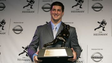 Dec 8, 2007; New York, NY, USA; Florida Gators quarterback Tim Tebow poses with the Heisman Trophy as he addresses the media at the Hard Rock Cafe after being awarded the 2007 Heisman Trophy in New York City.  Mandatory Credit: James Lang-Imagn Images