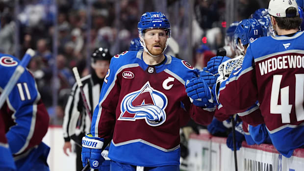Hockey player in brown uniform celebrates a goa