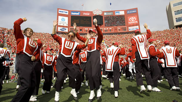 Wisconsin band members jump around during the 4th quarter tradition at Camp Randall