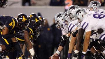 October 20, 2012; Morgantown, WV, USA; Kansas State Wildcats offense at the line of scrimmage against the West Virginia Mountaineers defense during the fourth quarter at Milan Puskar Stadium. The Kansas State Wildcats won 55-14. Mandatory Credit: Charles LeClaire-USA TODAY Sports