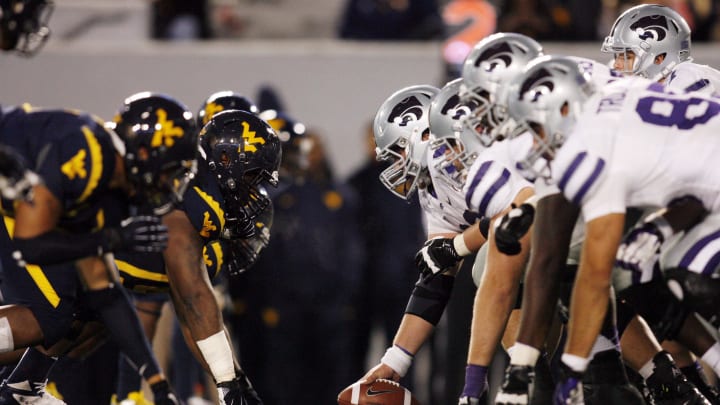 October 20, 2012; Morgantown, WV, USA; Kansas State Wildcats offense at the line of scrimmage against the West Virginia Mountaineers defense during the fourth quarter at Milan Puskar Stadium. The Kansas State Wildcats won 55-14. Mandatory Credit: Charles LeClaire-USA TODAY Sports