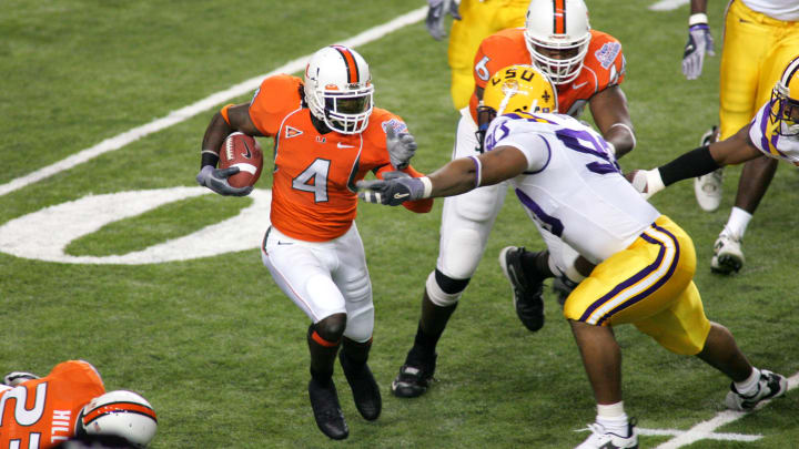 Dec 30, 2005; Atlanta, GA, USA; The Miami Hurricanes (4) Devin Hester runs back a kick as he gets a block from (6) Randy Phillips against the Louisiana State Tigers (90) Melvin Oliver in first half action at the Peach Bowl at the Georgia Dome. Mandatory Credit: Photo by Dale Zanine USA TODAY Sports Copyright (c) 2005 Dale Zanine 