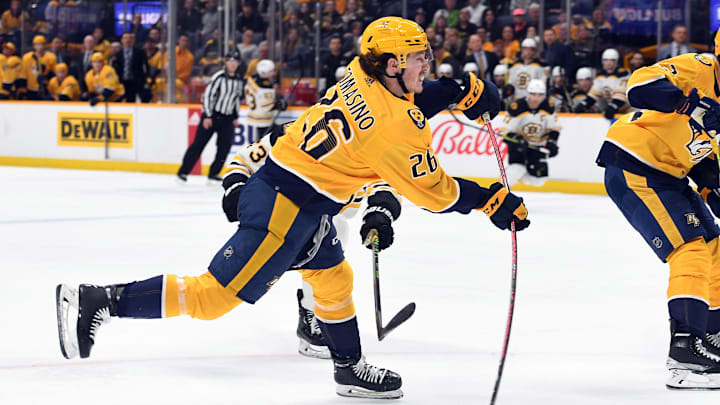 Feb 16, 2023; Nashville, Tennessee, USA; Nashville Predators center Philip Tomasino (26) shoots the puck during the first period against the Boston Bruins at Bridgestone Arena. Mandatory Credit: Christopher Hanewinckel-Imagn Images