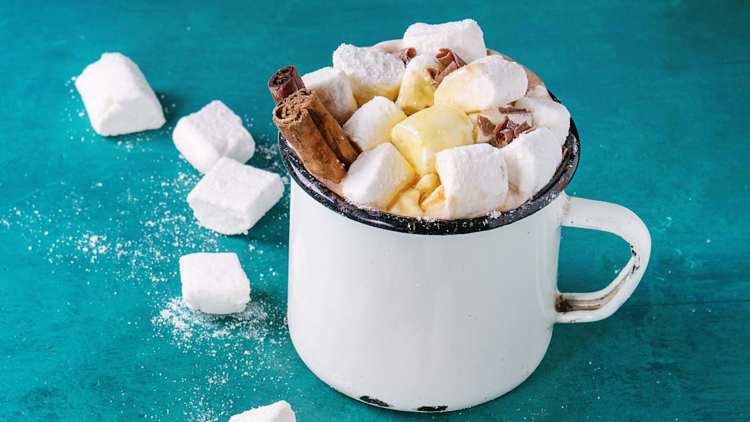 Hot chocolate with homemade marshmallow, chocolate chips, cinnamon sticks, and syrup